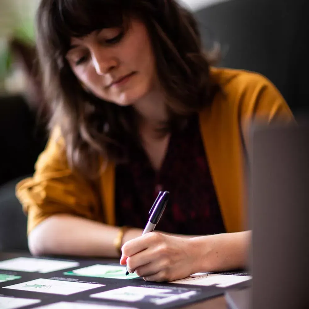 Student Meghan designing at a desk